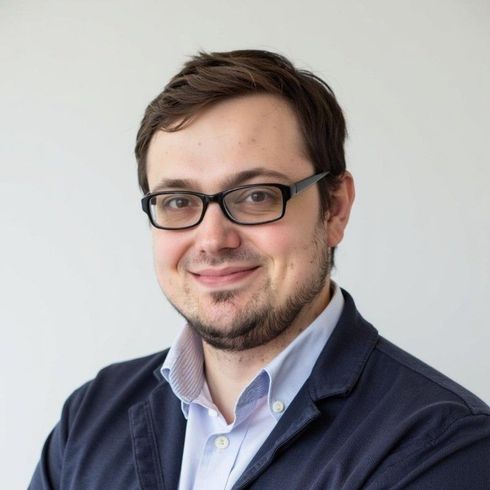A person in a yellow sweater and beret looks through small yellow binoculars against a solid yellow background.