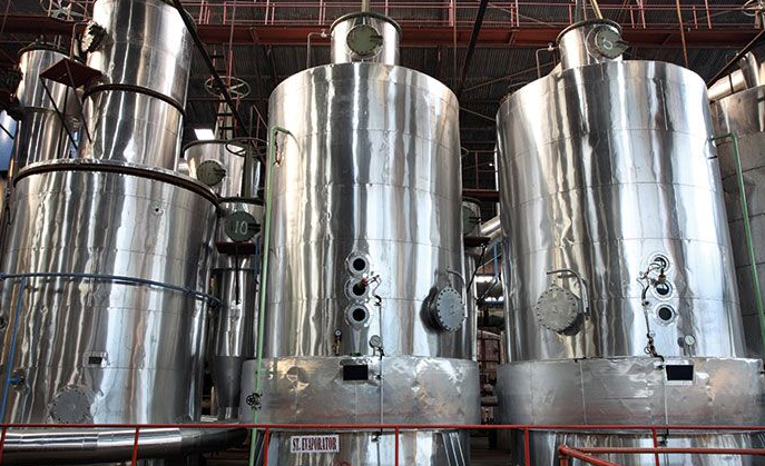 a row of stainless steel tanks in a factory .