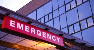 an emergency sign is above the entrance to a hospital .