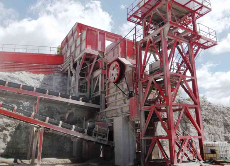 a large red and white machine is sitting on top of a hill .