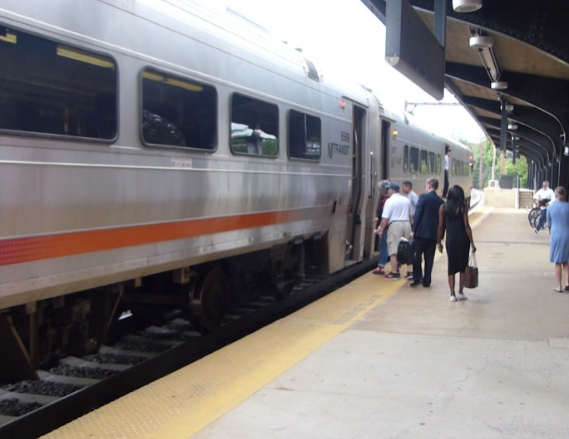 people are boarding a train at a train station