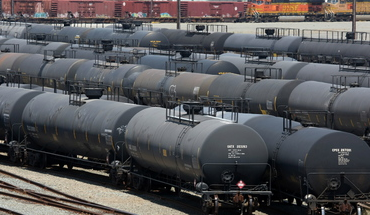 a bunch of train cars are parked next to each other