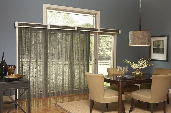 Cozy living room with bamboo shades, chaise lounge, and tan walls, natural light.