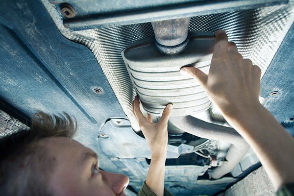 Mechanic Repairing The Muffler — Midland, TX — Midland Muffler & Brake