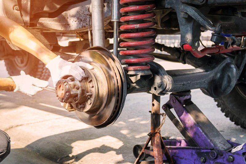 Mechanic Checking The Car Brakes — Midland, TX — Midland Muffler & Brake