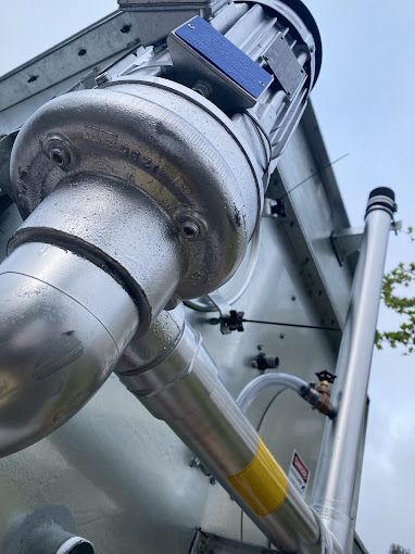 A close up of a metal pipe with a motor attached to it.