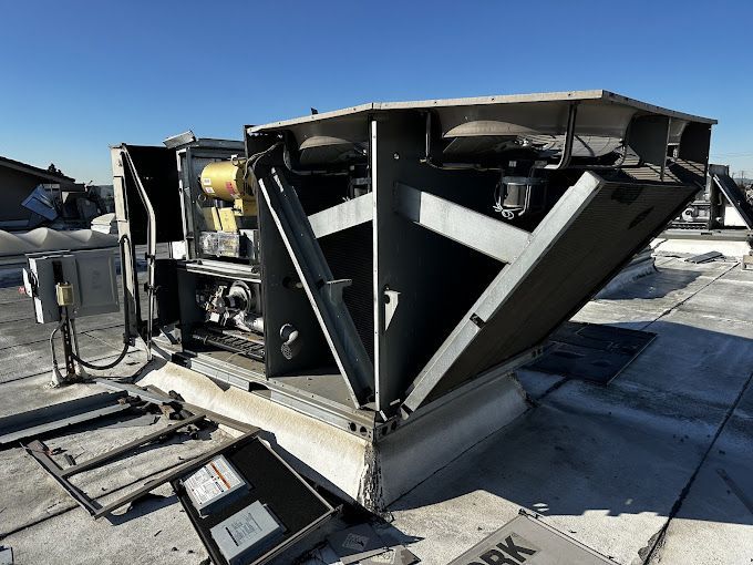 A large machine is sitting on top of a roof.