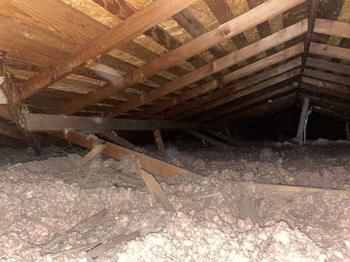 There is a lot of insulation in the attic of a house.