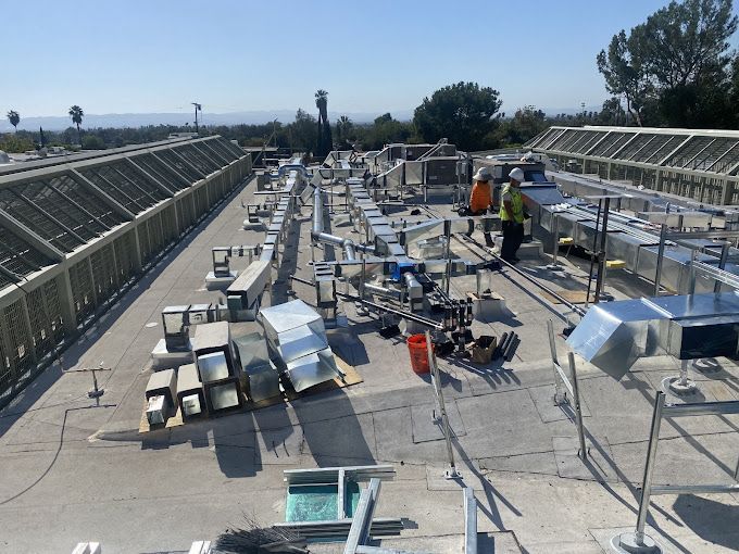 The roof of a building is being worked on by workers