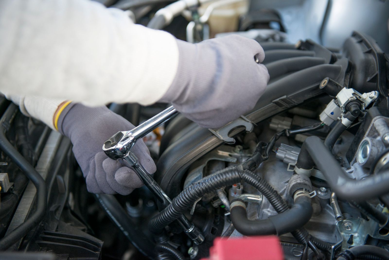 A man is polishing a car with a machine.