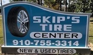 A Tire Shop With A Sign In Front Of It And Cars Parked In Front Of It - Leland, NC - Skip's Tire Center