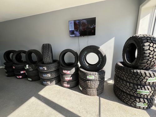 A Bunch Of Tires Are Stacked On Top Of Each Other In A Room - Leland, NC - Skip's Tire Center