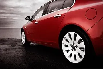 A Red Car Is Parked On The Side Of The Road - Leland, NC - Skip's Tire Center