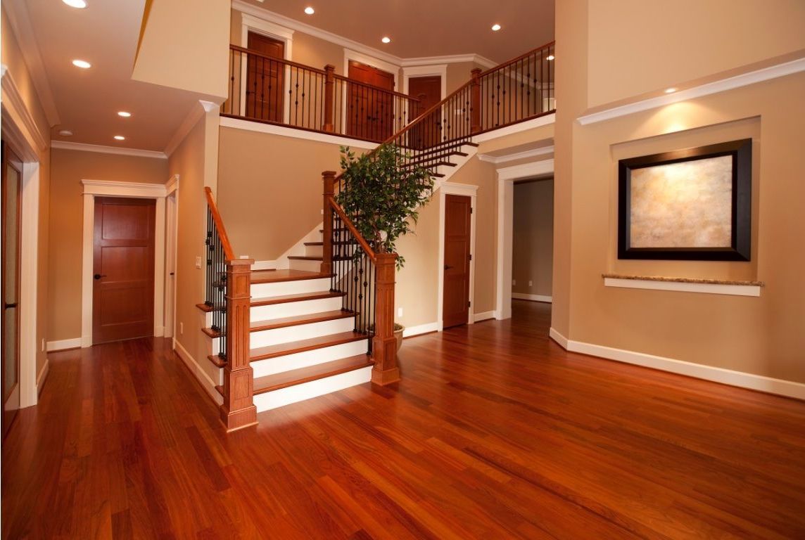 Hardwood floors and stairs that were recently restored with sanding and staining