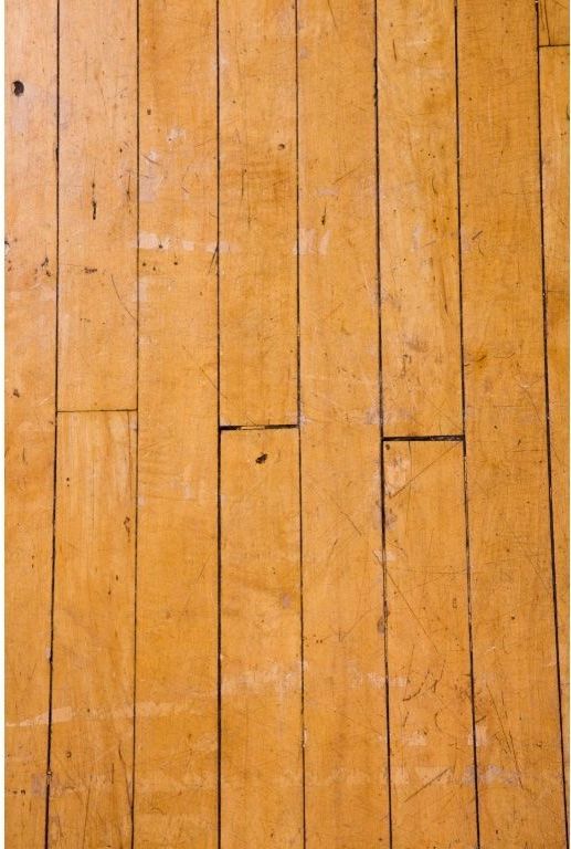 Close-up of hardwood flooring that is scratched and worn in a home in Toledo, OH