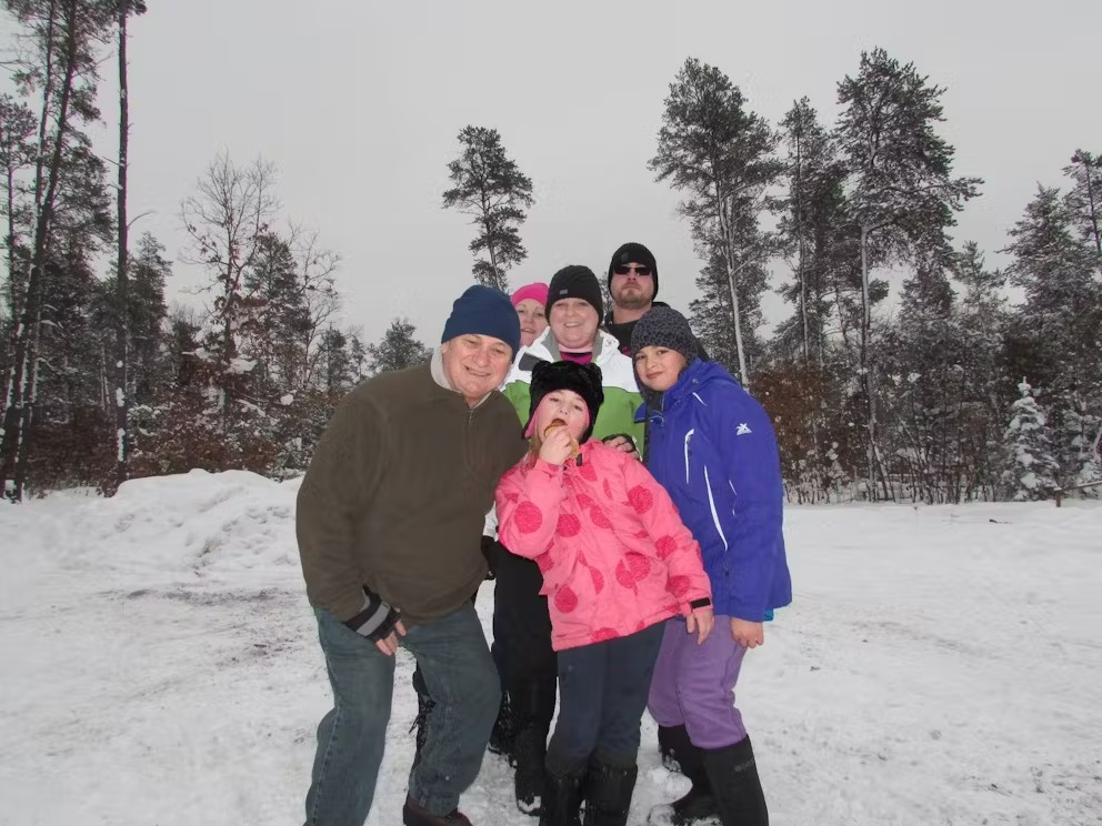 A group of people posing for a picture in the snow