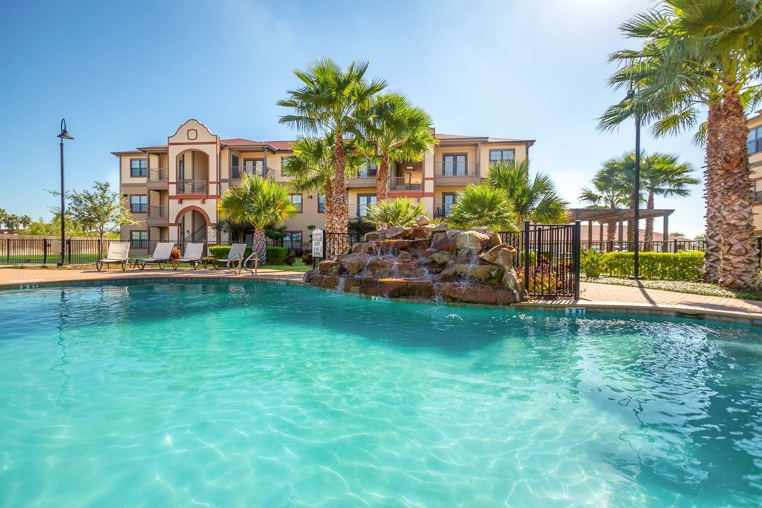 A large building with a swimming pool in front of it