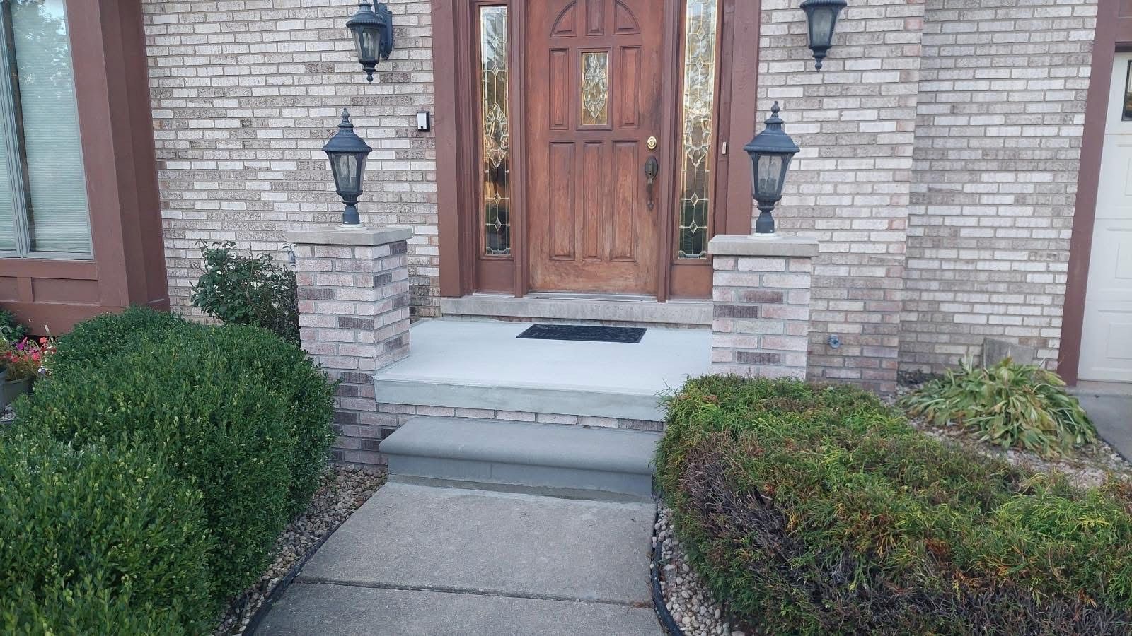 A blue adt sign is sitting next to a set of concrete steps.