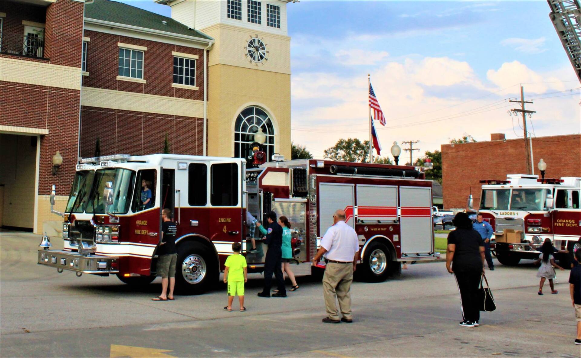 A fire truck is parked in front of a fire station