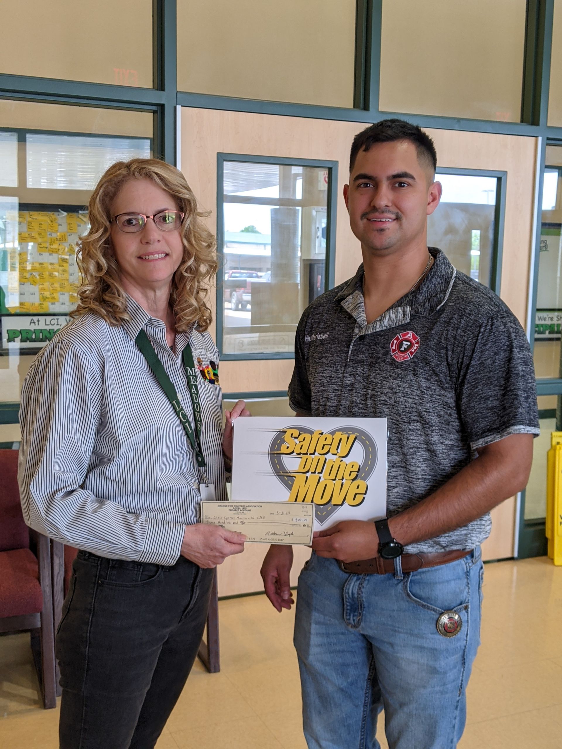 A man and a woman are standing next to each other in a room.