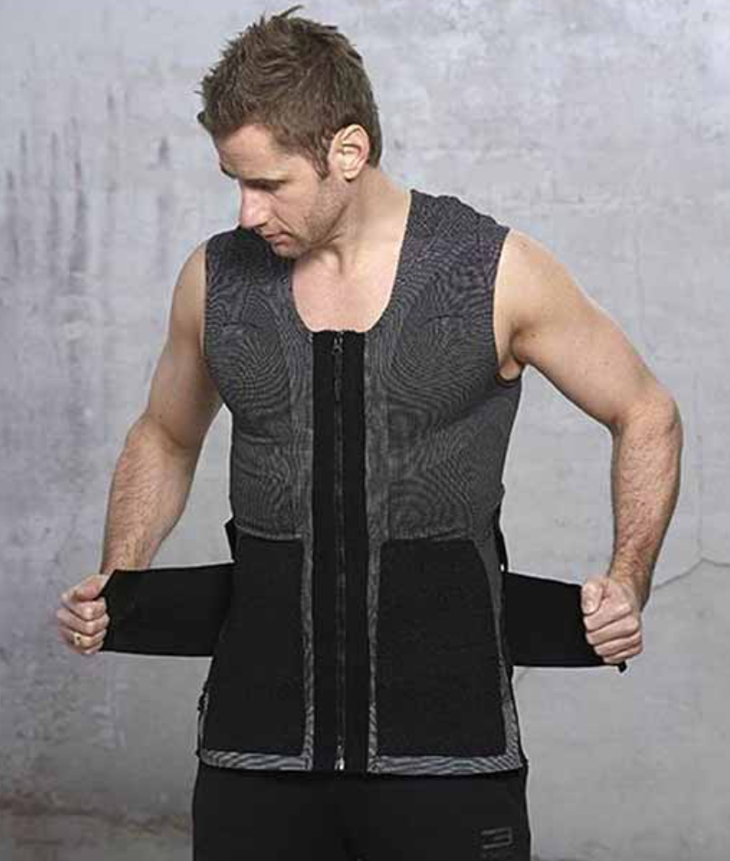 Man wearing a gray cooling vest, adjusting the side straps.