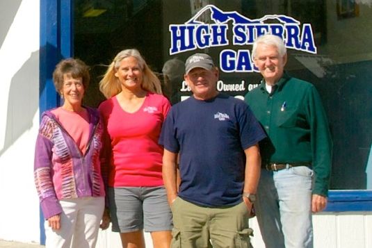 A group of people standing in front of a high sierra gas station