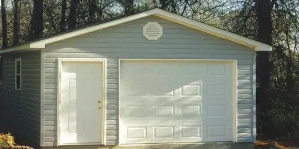 a white garage with a white door and a white roof