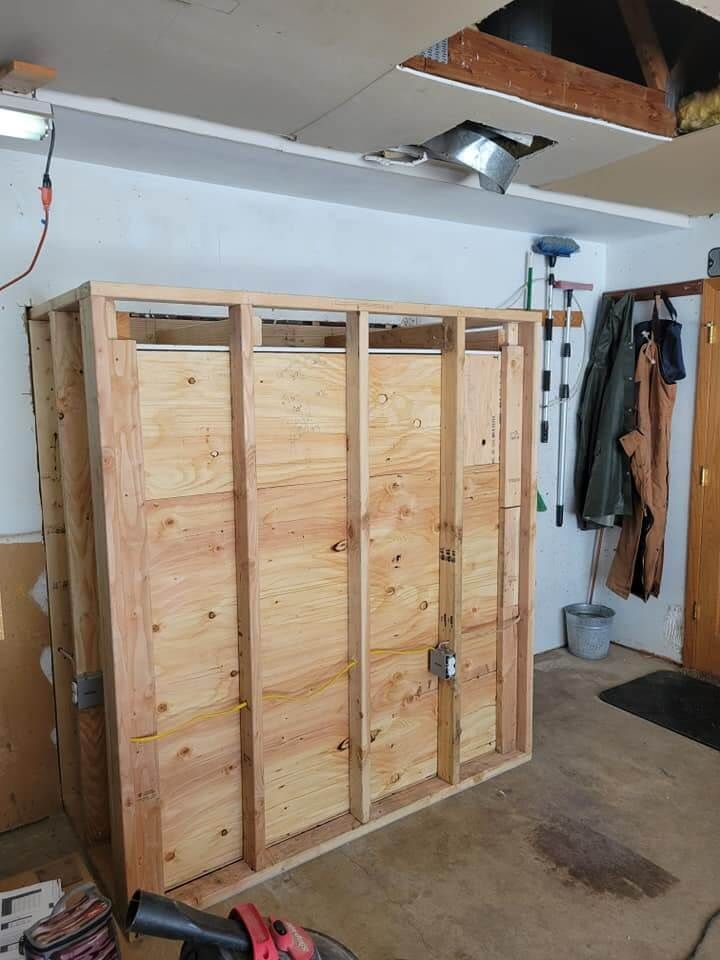 A wooden structure is being built in a garage.
