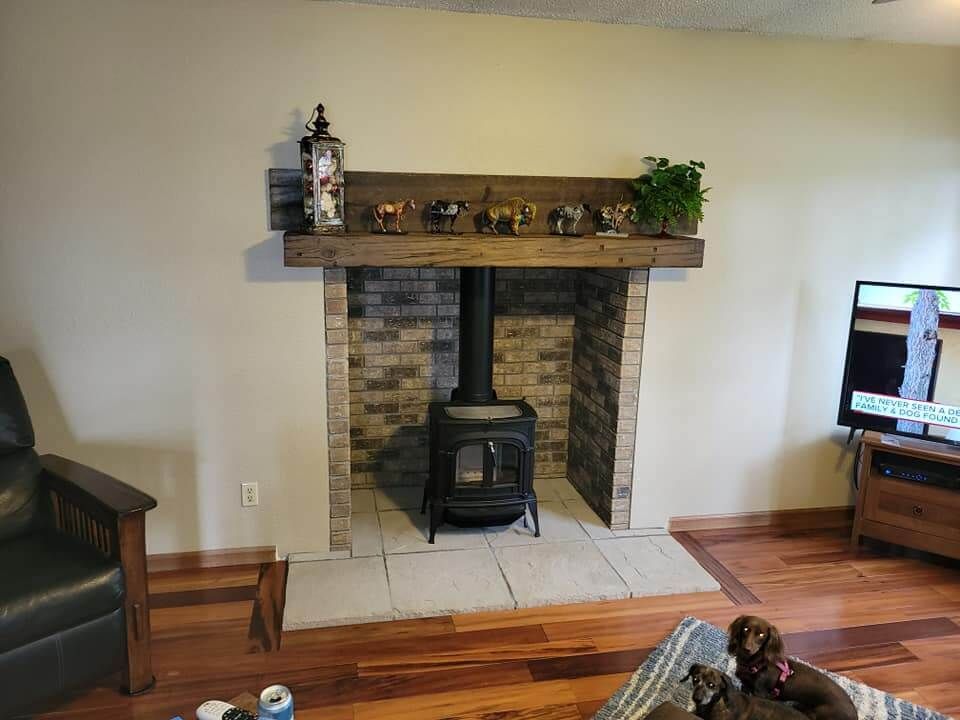 A living room with a fireplace and a wood stove.