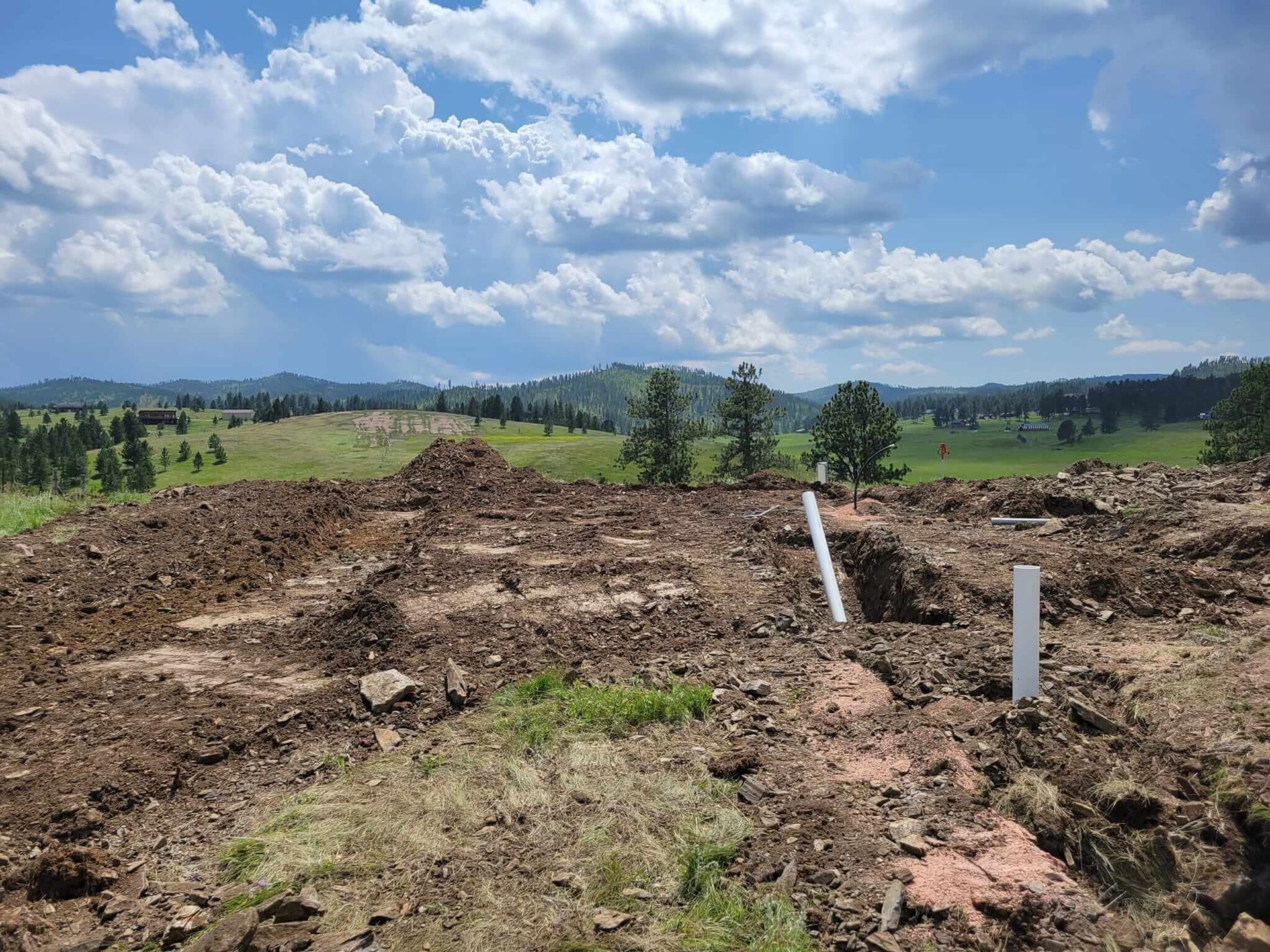 A large pile of dirt is sitting in the middle of a field.