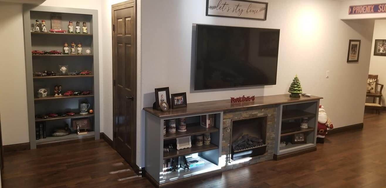 A living room with a flat screen tv and a fireplace.