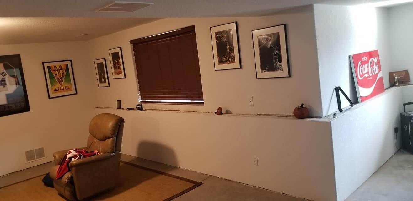 A living room with a coca cola sign on the wall