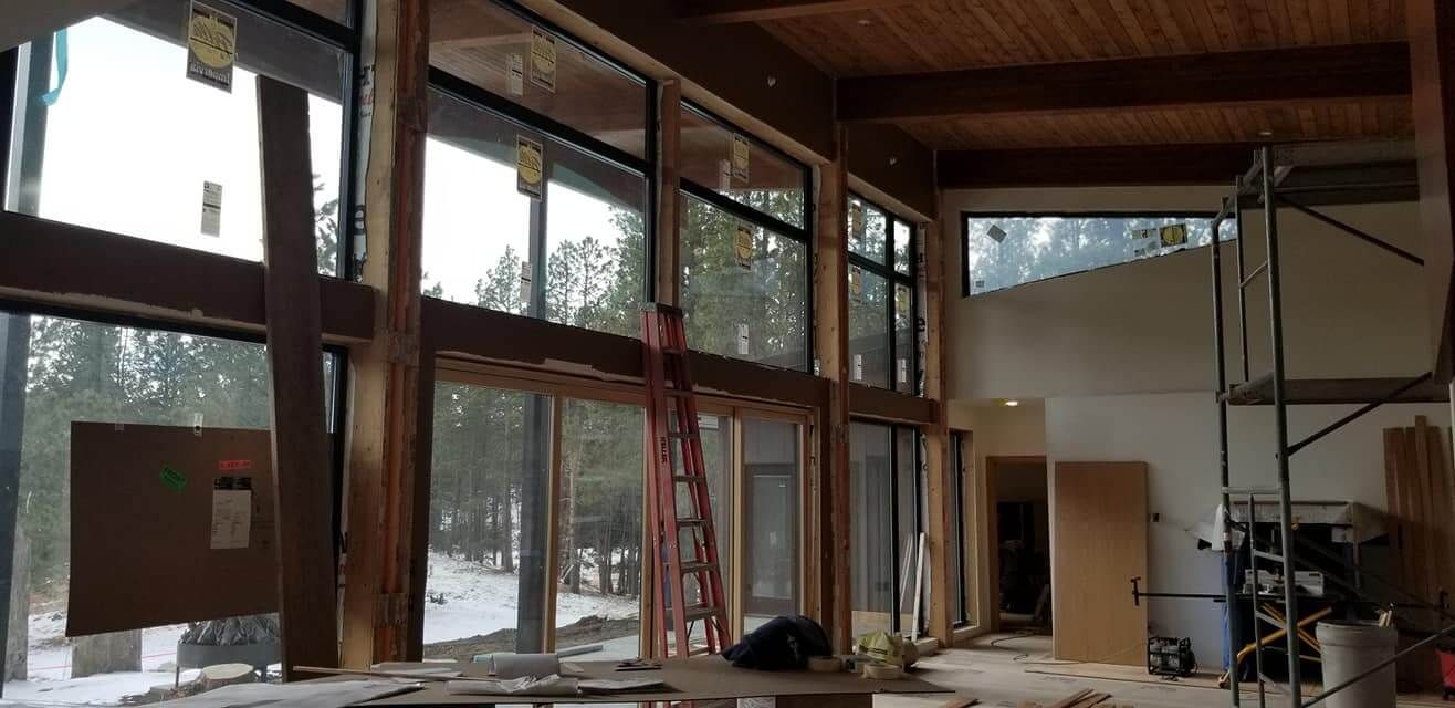 A large room with a lot of windows and a ladder.