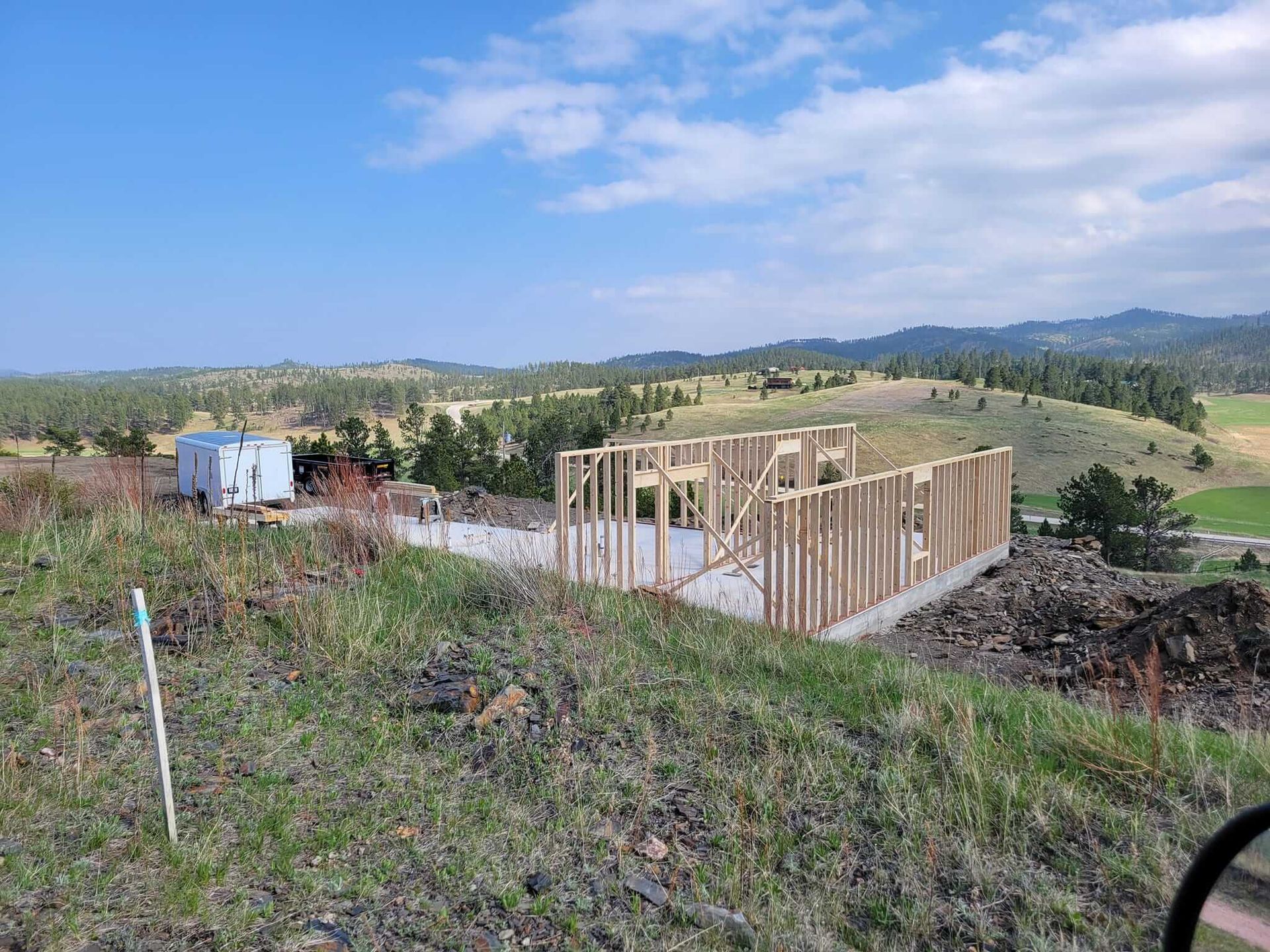 A house is being built on top of a hill.