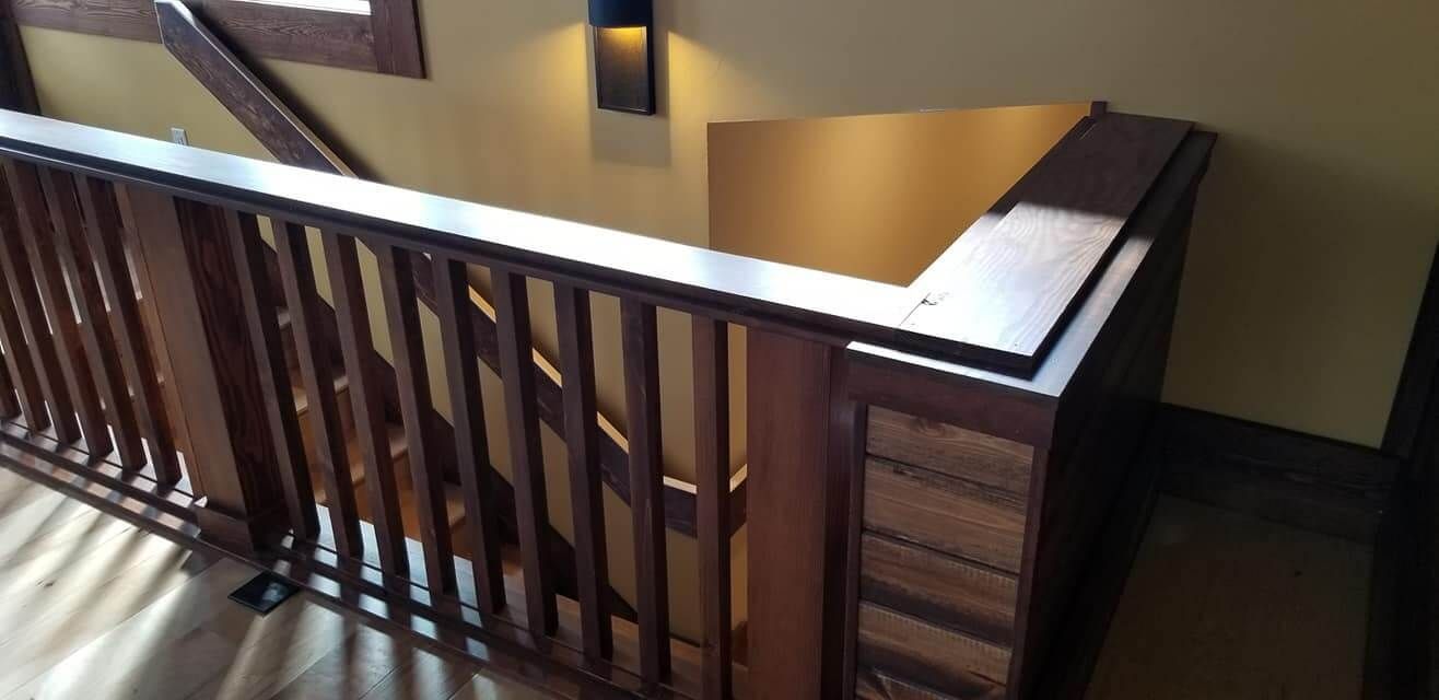 A wooden railing on a staircase in a house