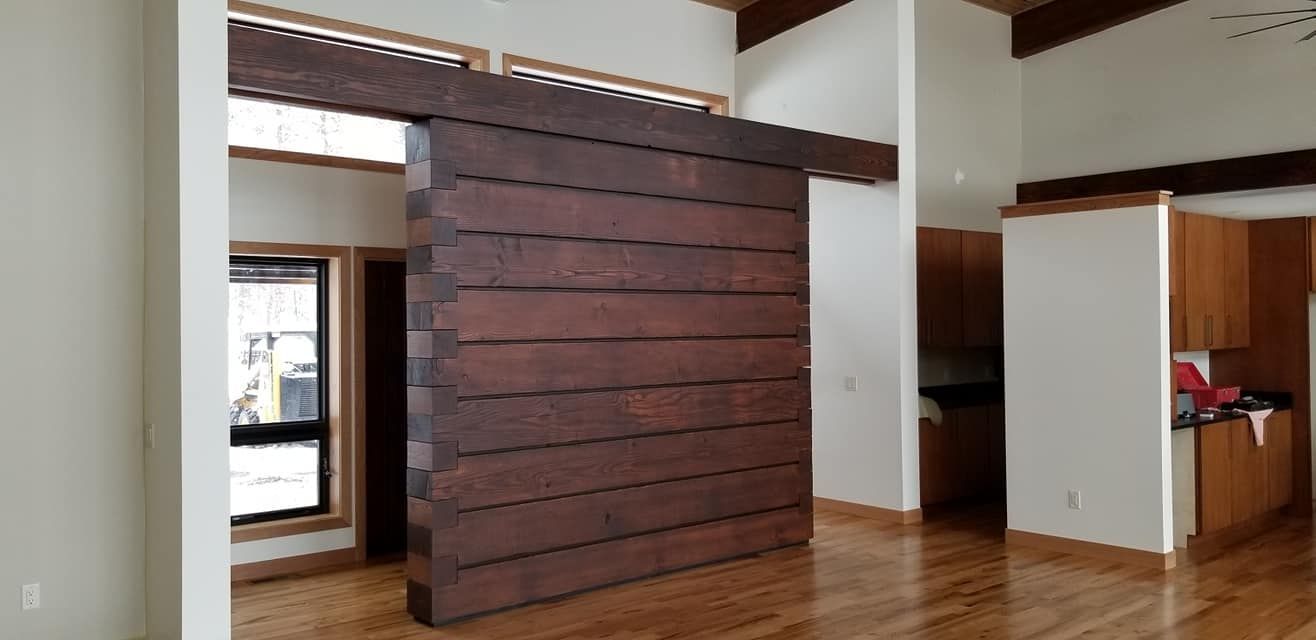 An empty room with a wooden sliding door between two rooms.