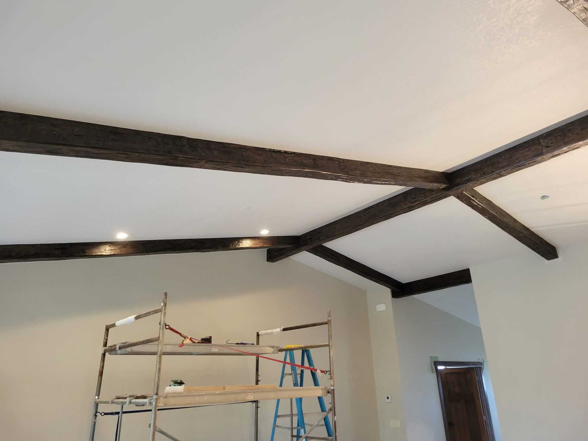 A room with a ladder and a white ceiling