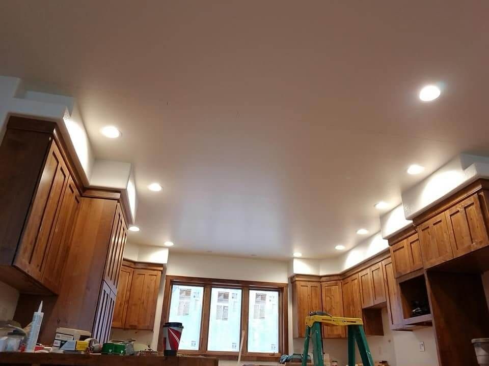 A kitchen with wooden cabinets and a white ceiling.