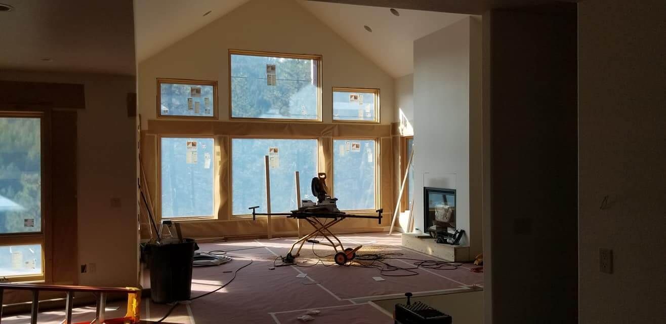 A room that is being remodeled with a lot of windows