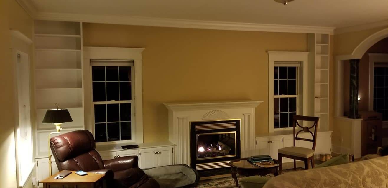 A living room with a fireplace and a chair