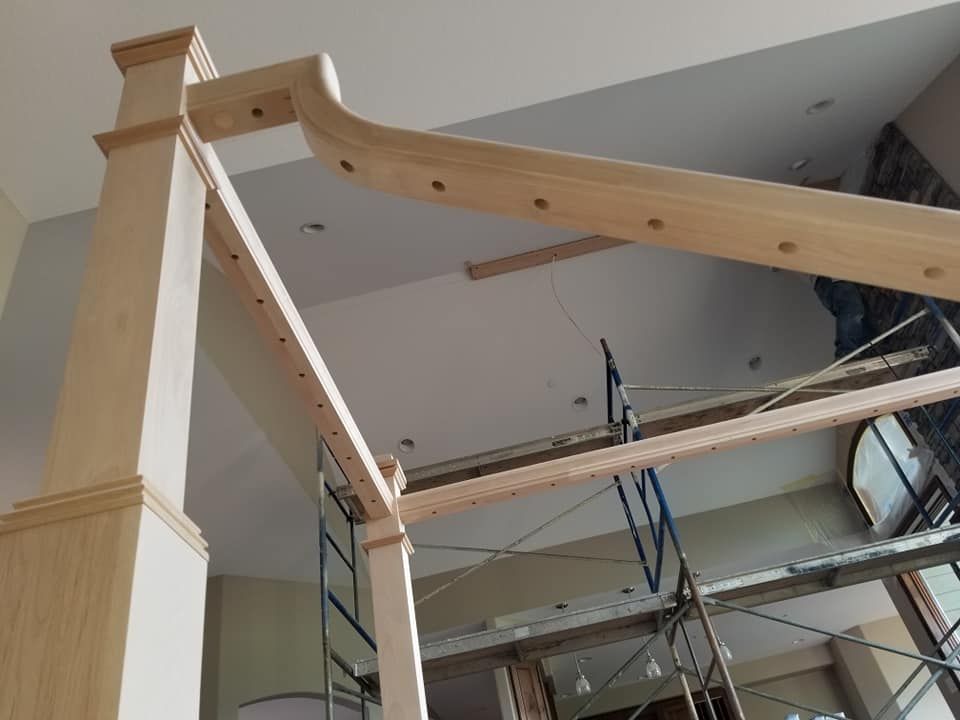 A wooden structure is being built in a room with scaffolding.