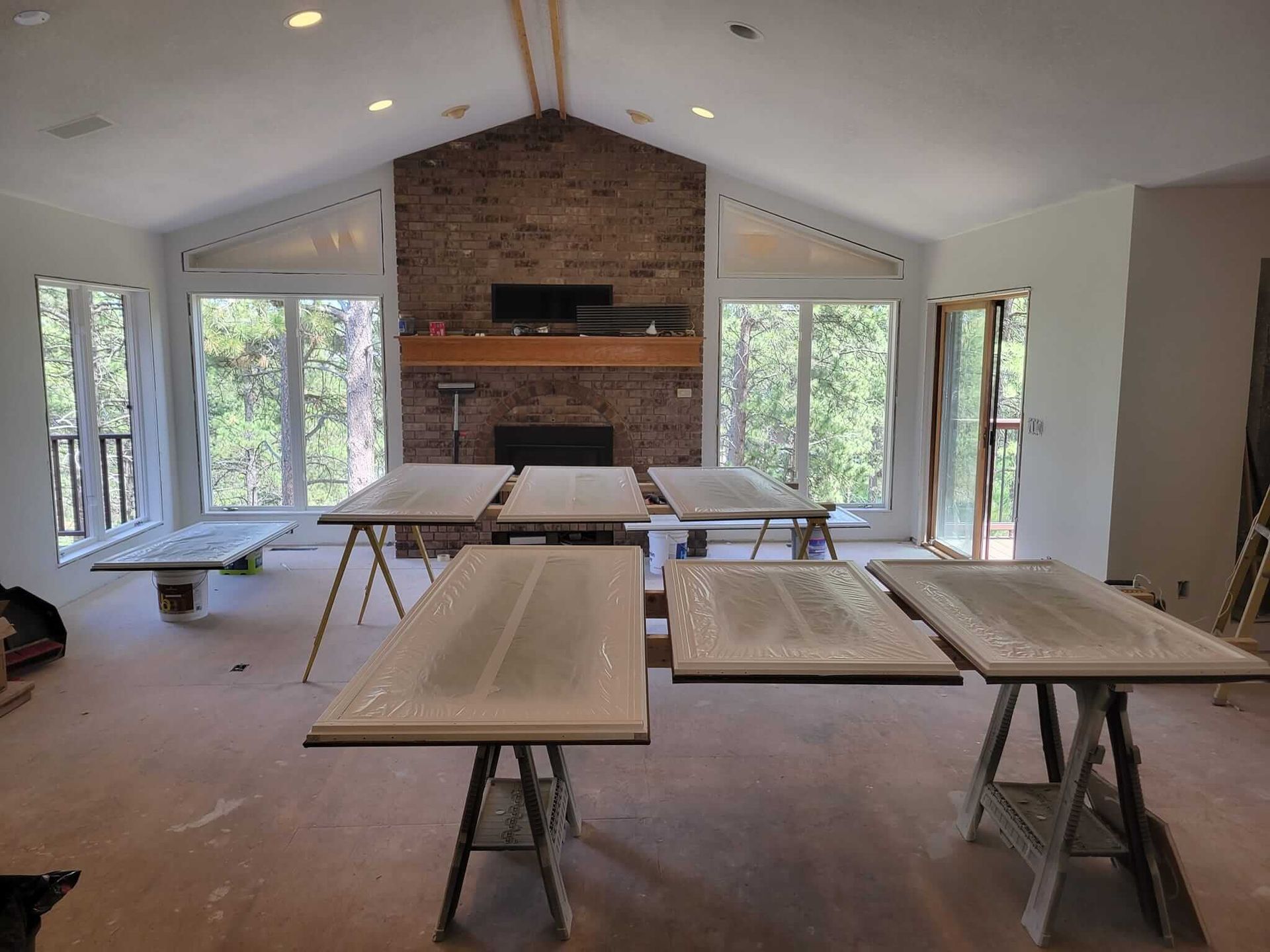 A large room with tables and a fireplace in the background.