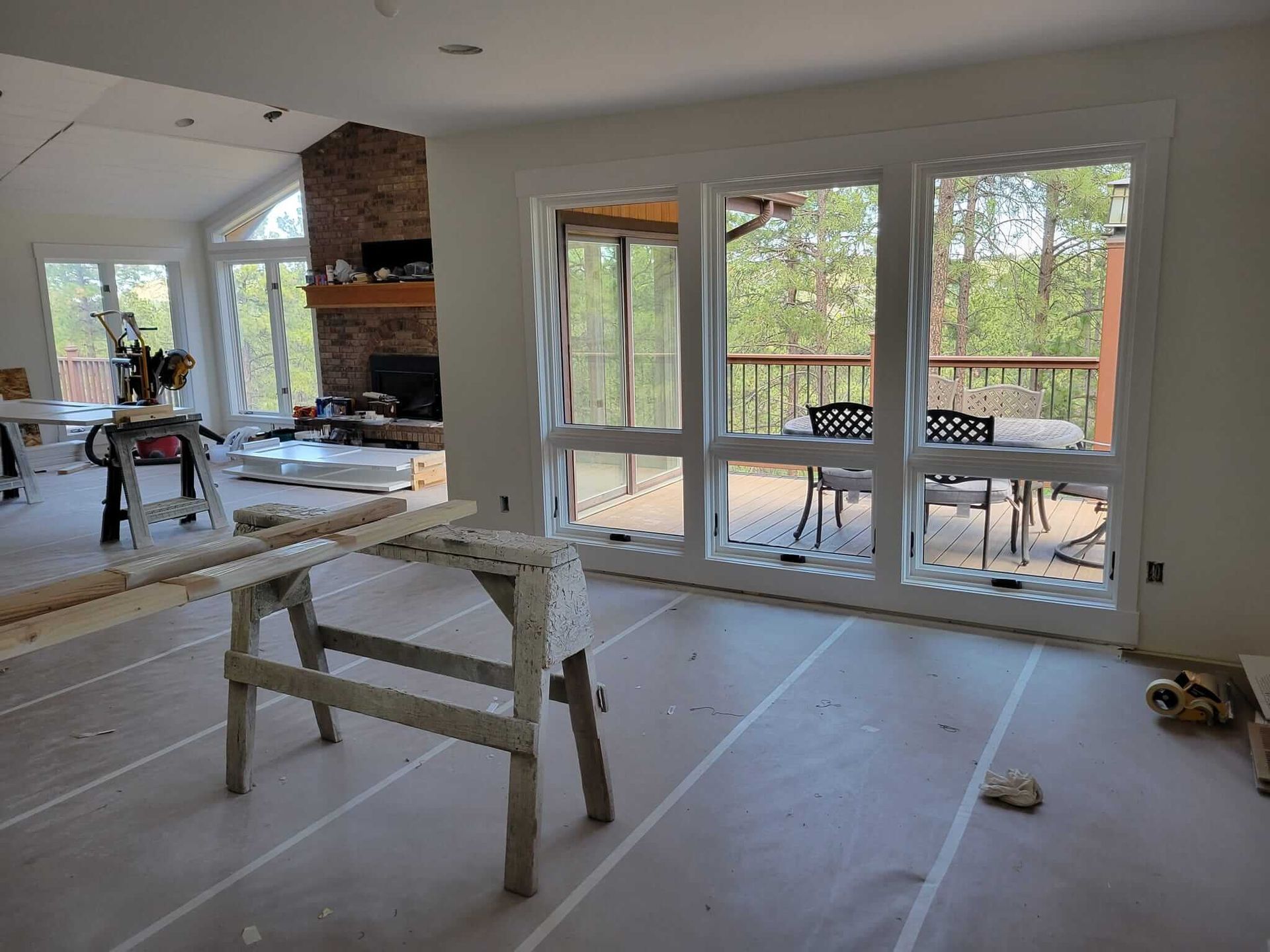 A room with a lot of windows and a table and chairs in it.