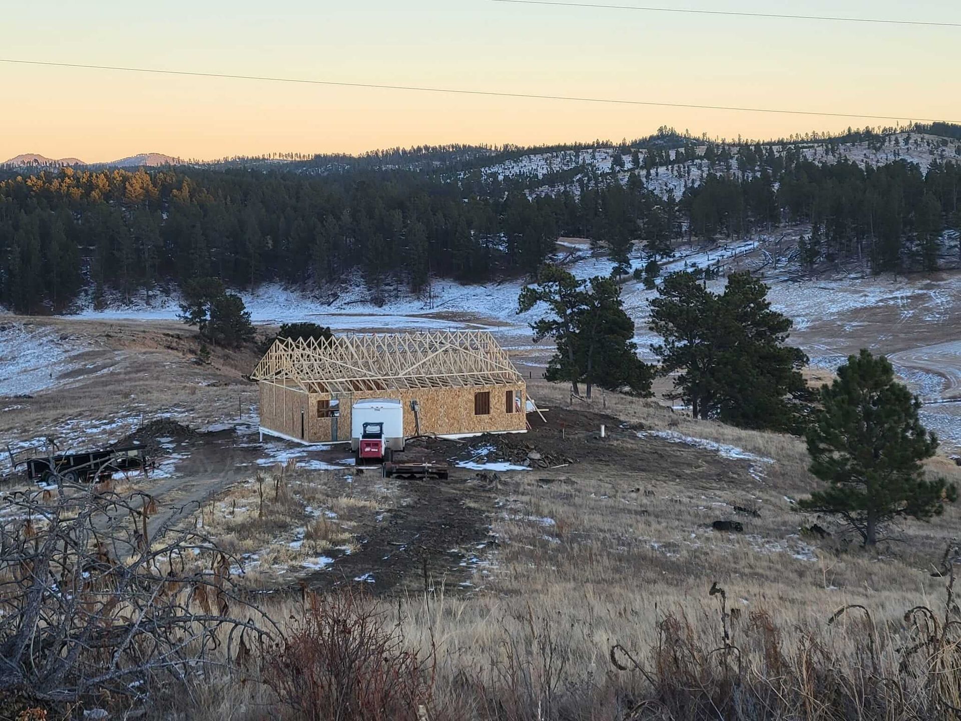 A house is being built in the middle of a snowy field