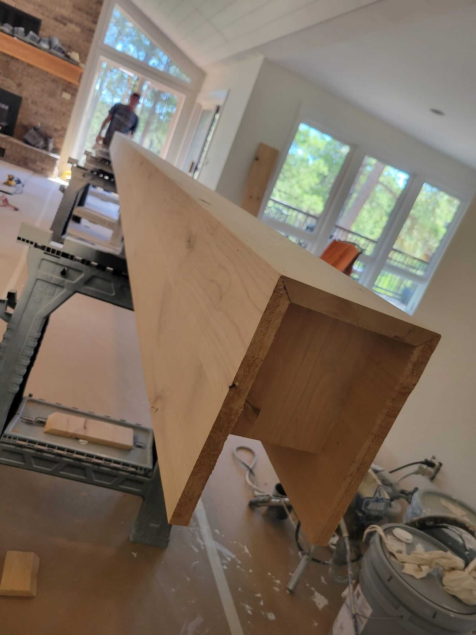 A large piece of wood is sitting on top of a table in a living room.