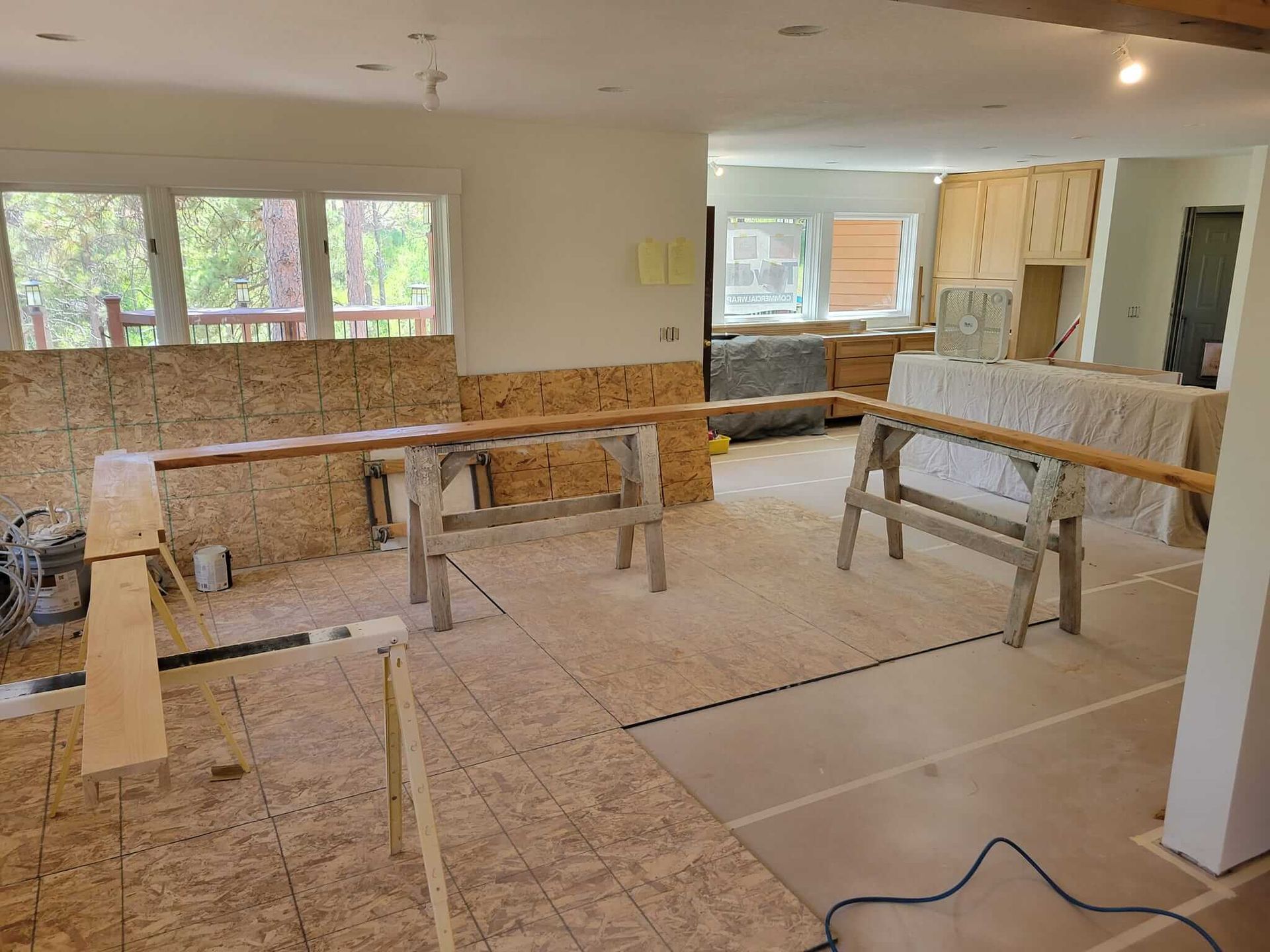 A room with a lot of wood and two horses in it.