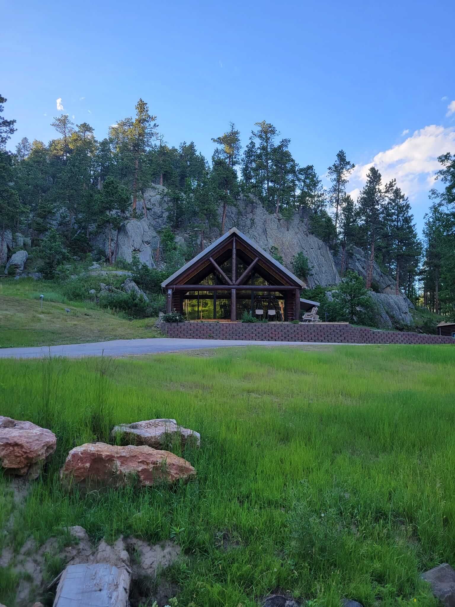 There is a pavilion in the middle of a grassy field.