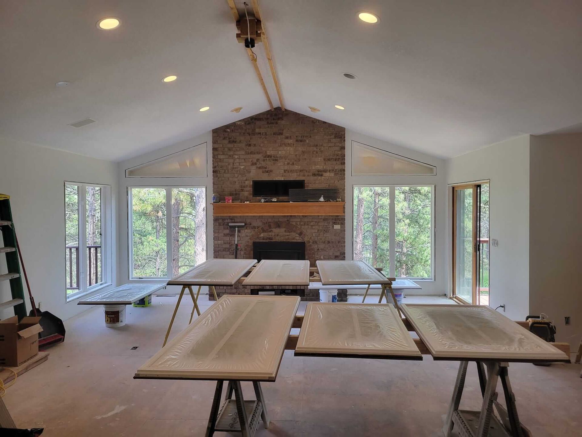 A large living room with a fireplace and a lot of windows.
