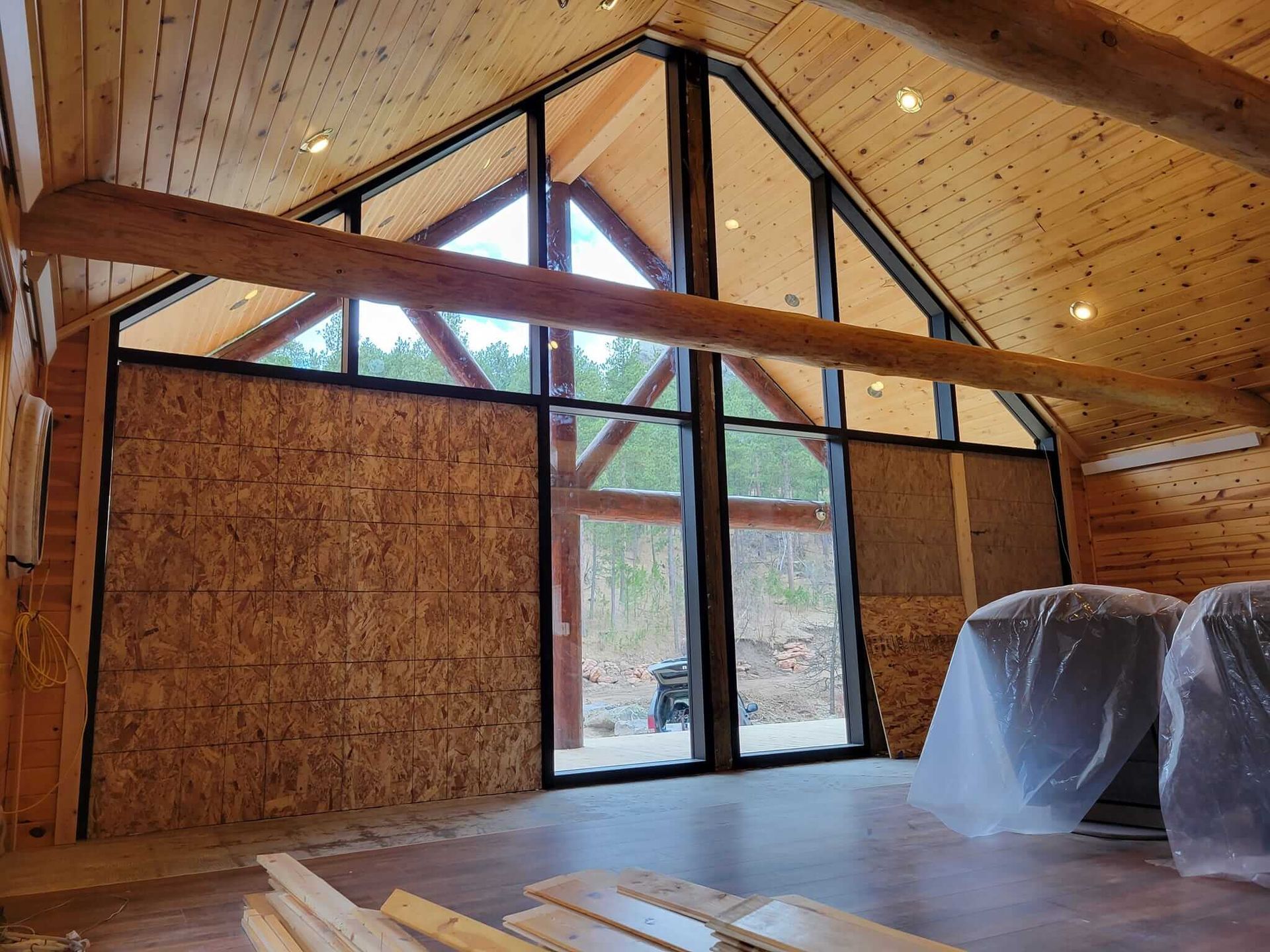 A room with a lot of windows and a wooden ceiling