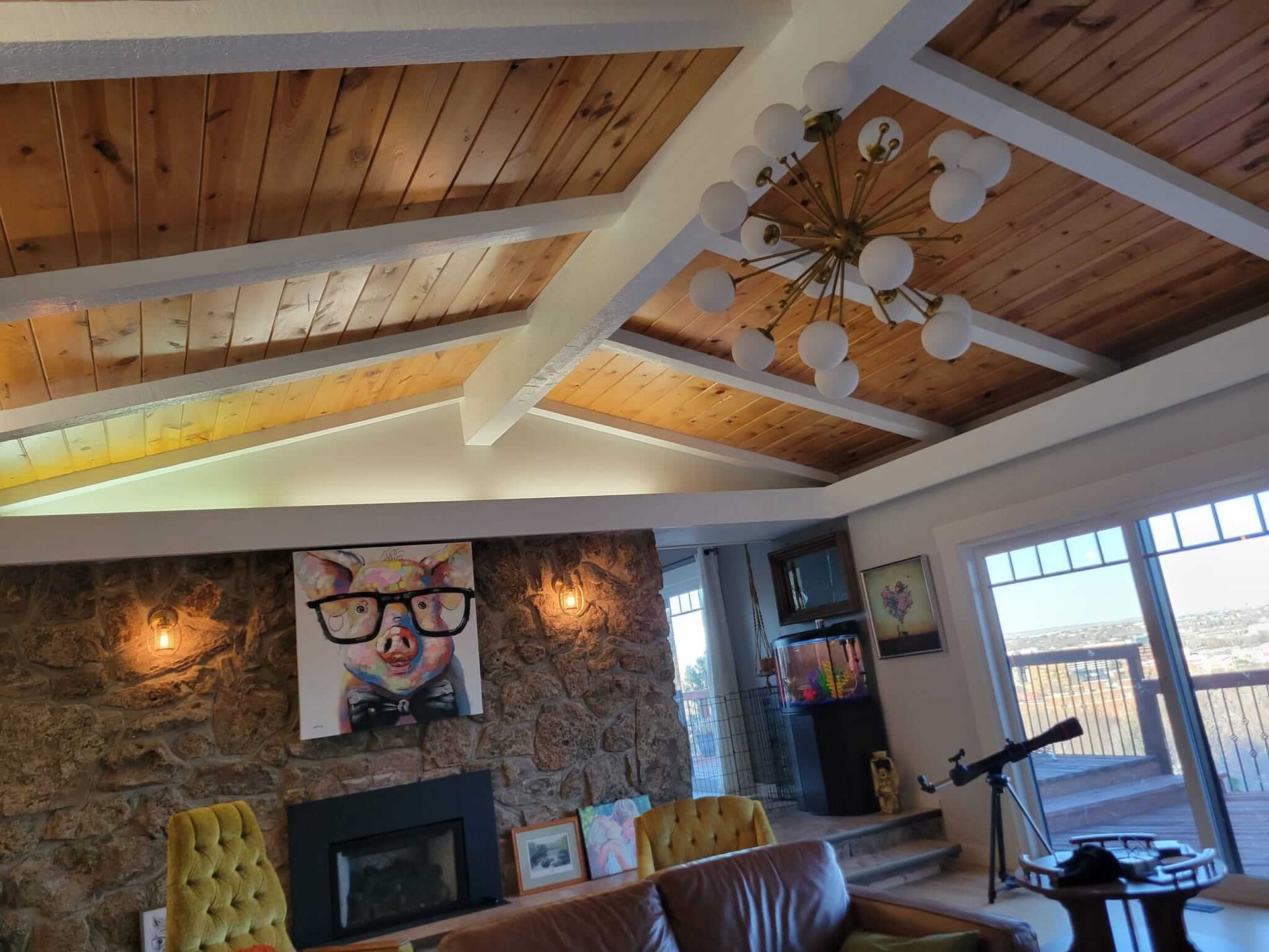 A living room with a painting of a cat wearing glasses on the wall